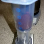 An inverted AeroPress on a scale with coffee weighing 15g.