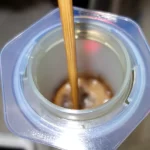 Chopstick stirring coffee in an AeroPress.