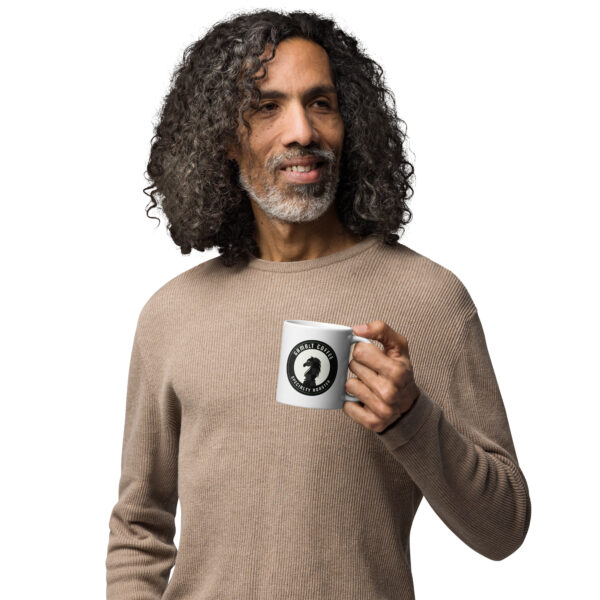 Man holding a white Gambit Coffee coffee mug.