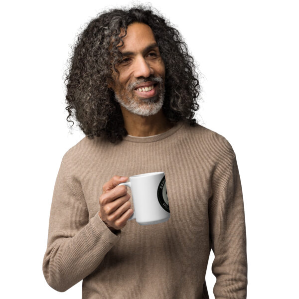 Man holding a white Gambit Coffee coffee mug in his right hand.