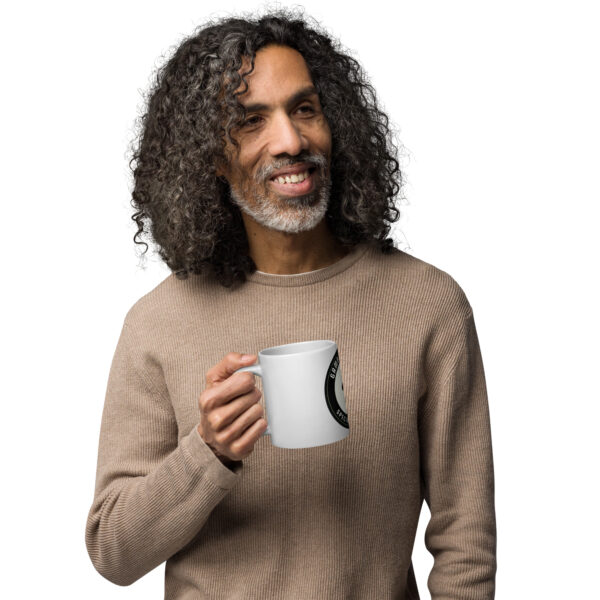 Man holding a white Gambit Coffee coffee mug.